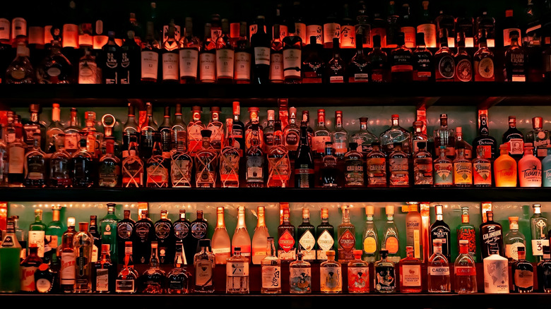 Bottles of alcohol and spirits on shelves at a bar