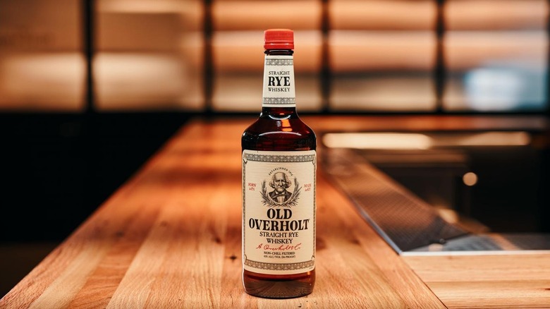 Bottle of American Rye Whiskey Old Overholt on a bar top.