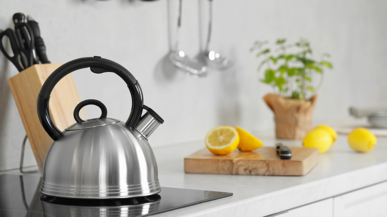 Kettle and lemons on kitchen counter