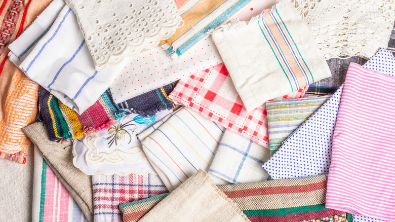 Pile of mismatched linens and fabric for napkin projects