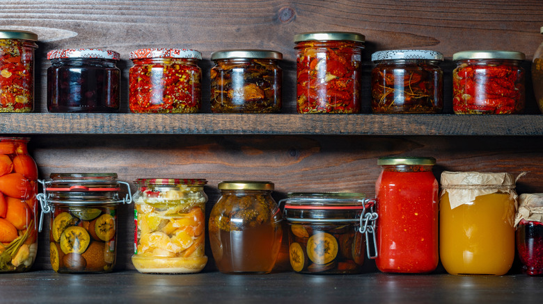 pantry shelf with various jars of condiments