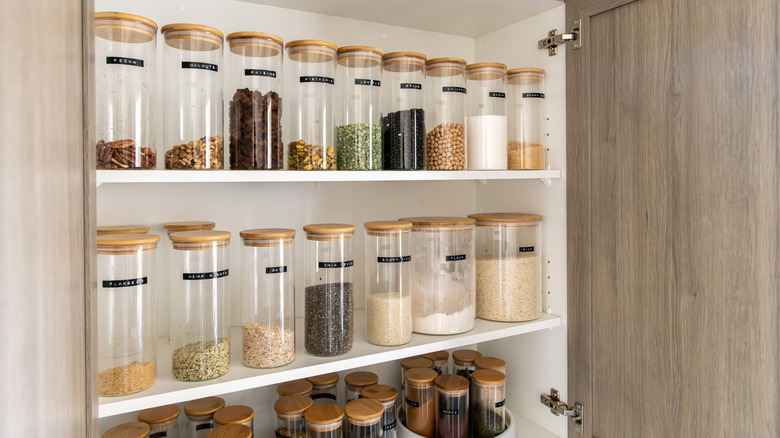 glass jars in a kitchen cabinet