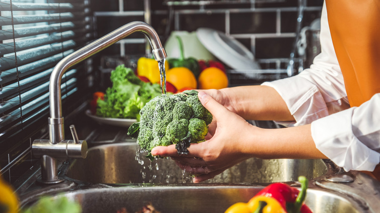 A person washing vegetables
