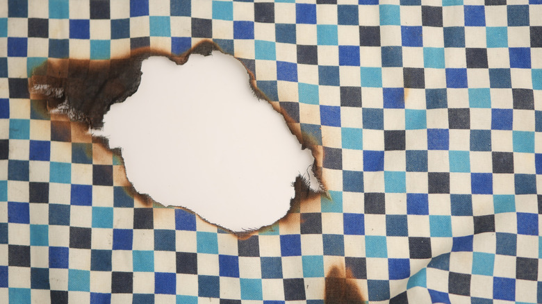 Fabric with burned hole in middle