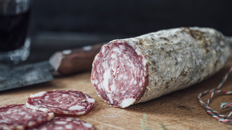 A line of cured salami hanging on string
