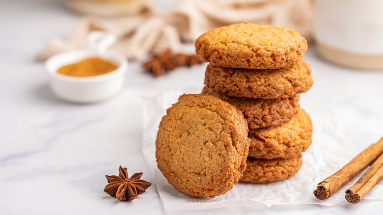 stack of homemade cookies surrounded by spices