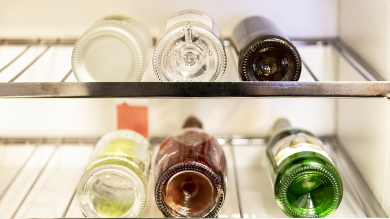 Bottles of alcohol laying in refrigerator