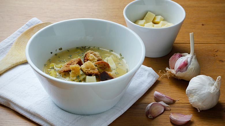 garlic cloves with a bowl of soup