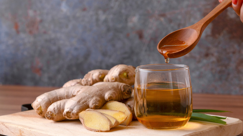 Cup of tea with ginger root on table