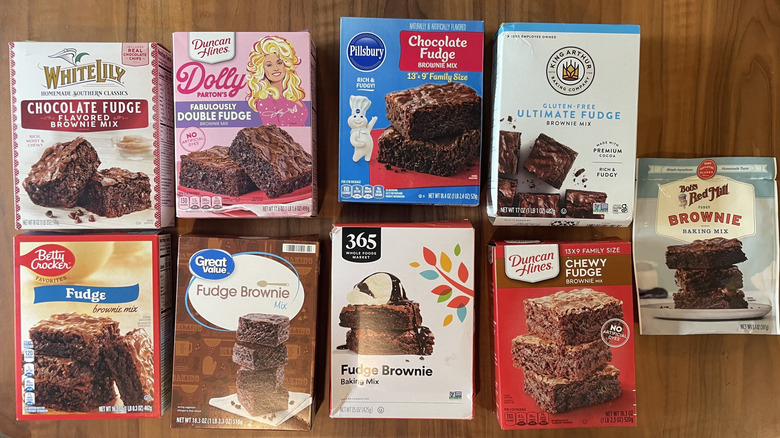 Assorted brands of boxed brownie mix laid out on a table