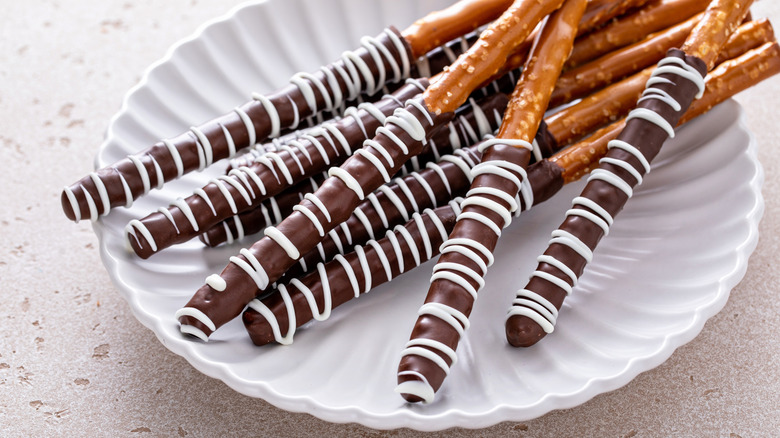 Pretzel rods covered with chocolate frosting