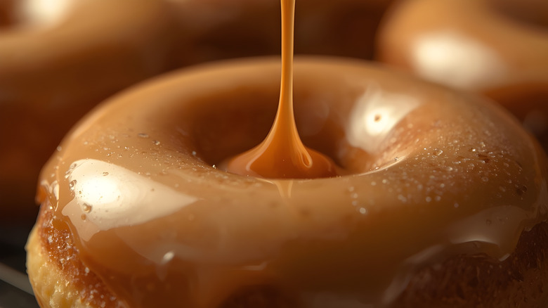 Glaze dripping onto a donut close up