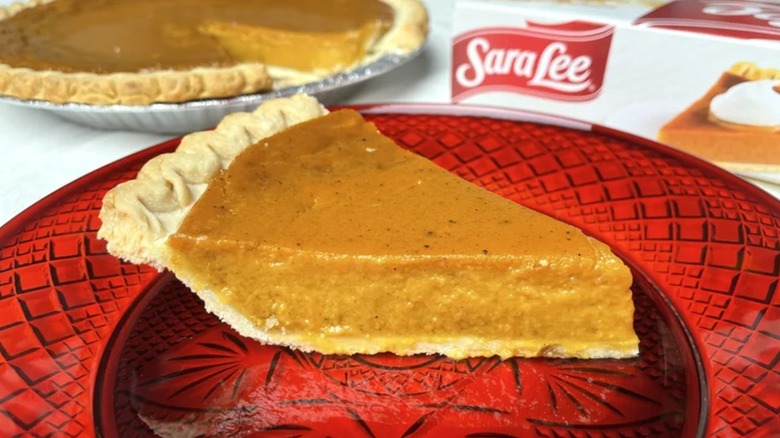 Sara Lee Sweet Potato Pie slice in front of the whole pie and its packaging