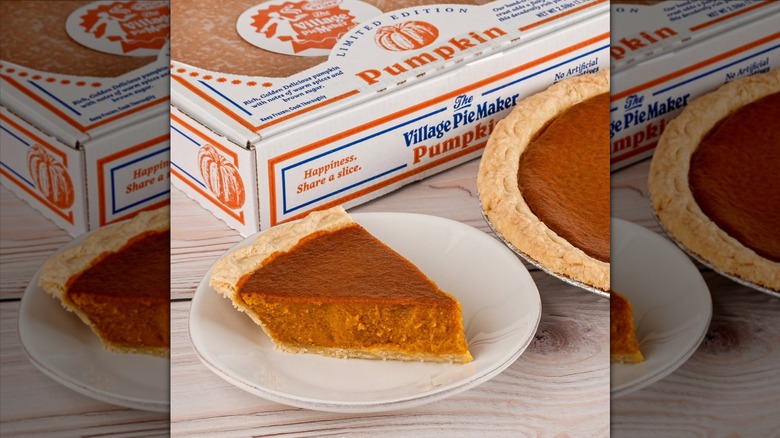 The Village PieMaker Pumpkin Pie slice next to the whole pie and its packaging