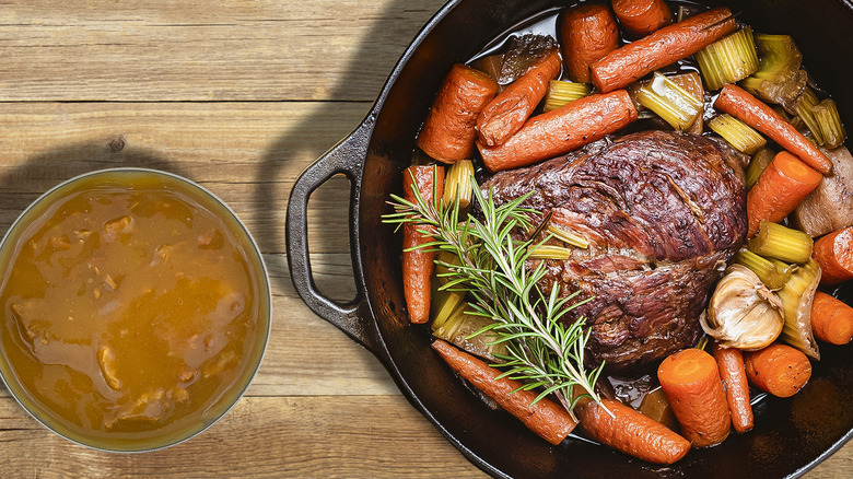 Pot roast and gravy on cutting board