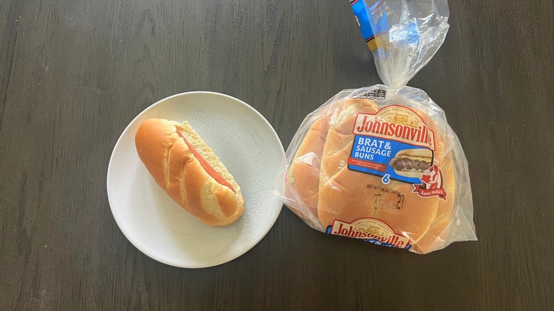 Aunt Millie's Johnsonville Brats and Sausage Bun pack with prepped hot dog on plate
