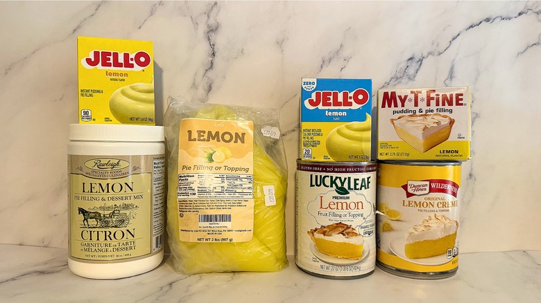 Seven lemon pie fillings and filling mixes on marble surface