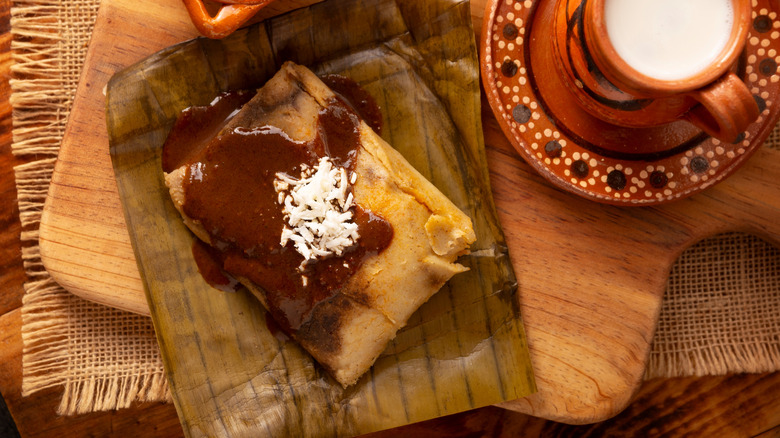 Opened tamale on a wooden board