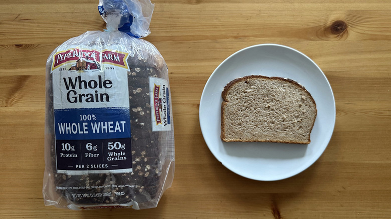 Pepperidge Farm 100% Whole Wheat Whole Grain Bread package and slice on a white plate on a table