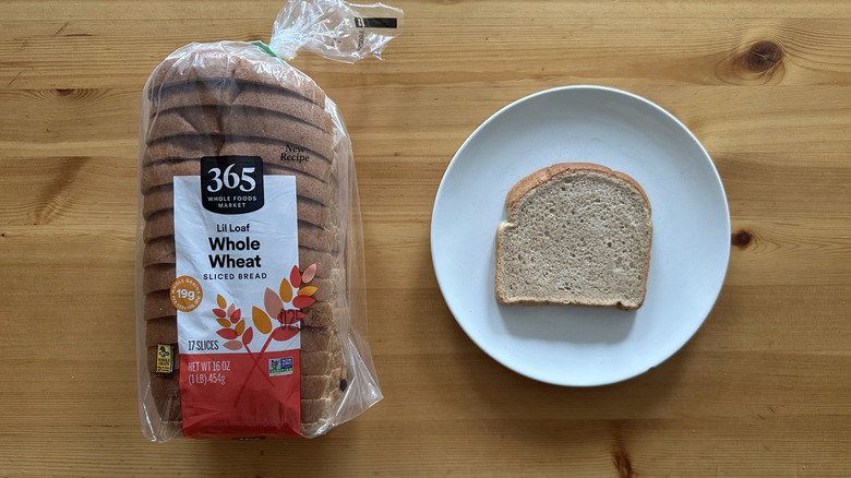 365 Whole Wheat Bread package and slice on a white plate on a table