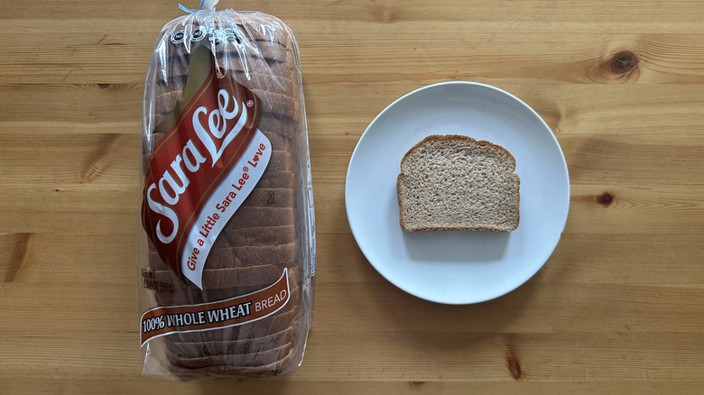 Sara Lee 100% Whole Wheat Bread package and slice on a white plate on a table