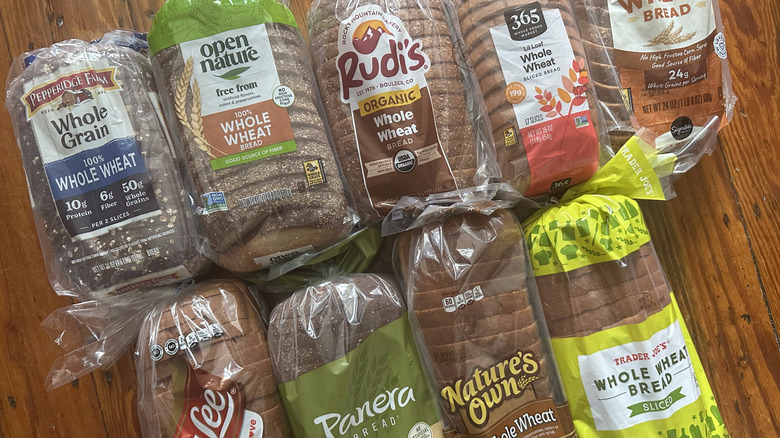 Loaves of whole wheat bread on a wooden background