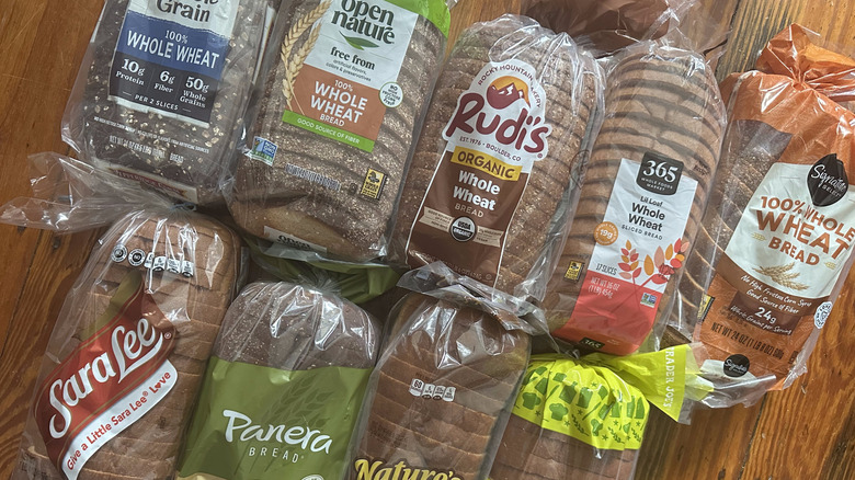 Loaves of whole wheat bread on a wooden background