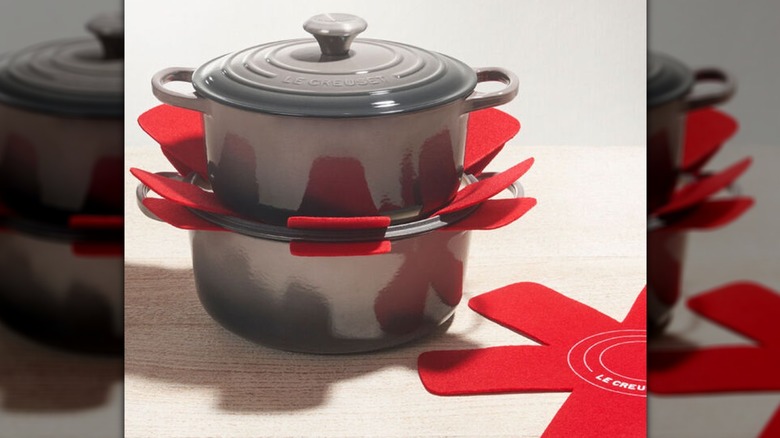View of stacked Le Creuset Pans with pan protectors