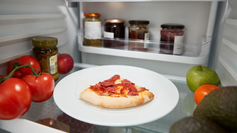 plate of pizza in fridge