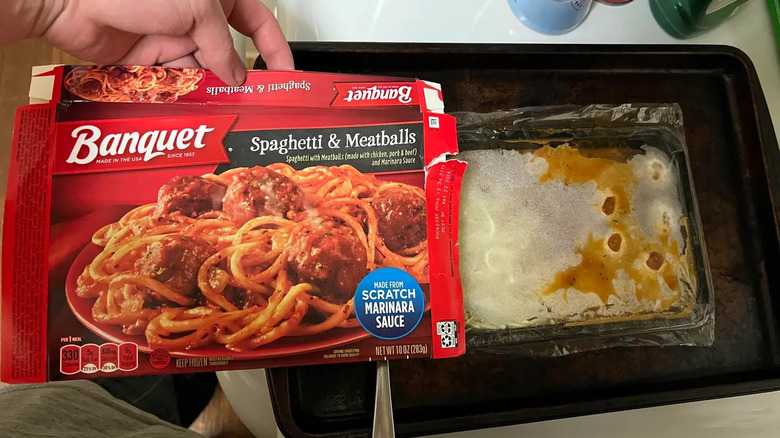 A person opening a Banquet's Spaghetti & Meatballs