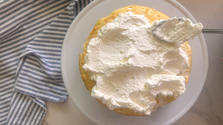 hand adding whipped cream