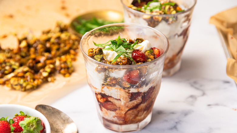 Side view of two Strawberry Balsamic Sundaes on table with toppings