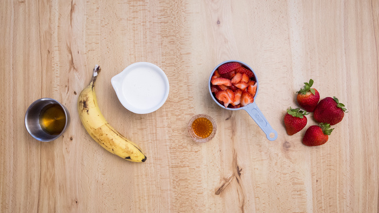 banana, strawberries, and other fruit popsicle ingredients on table
