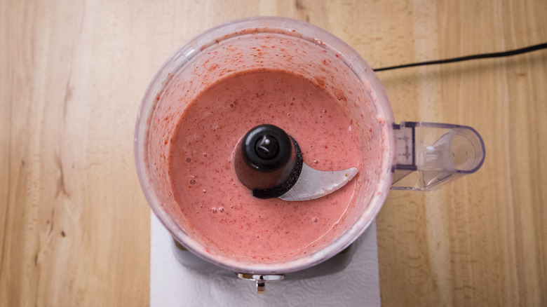 Aerial view of blended strawberries in food processor