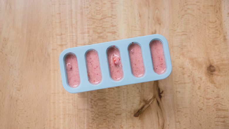 aerial view of filled popsicle molds on table