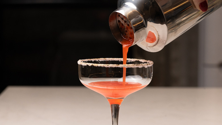 pouring cocktail into glass