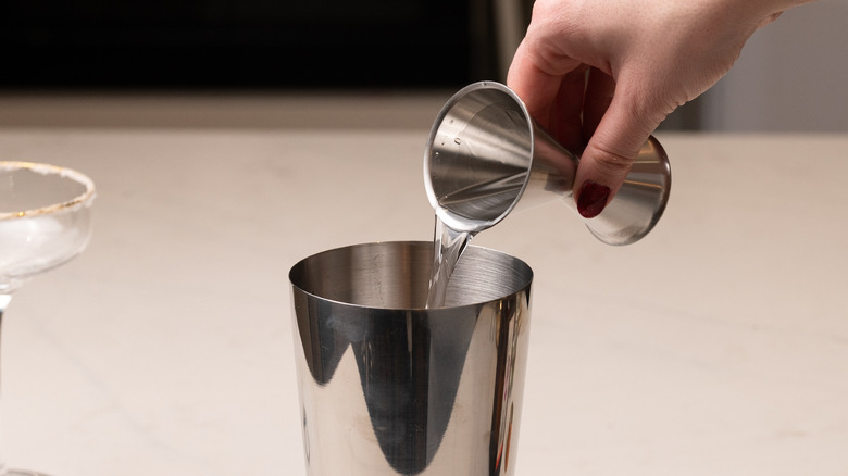 pouring vodka into cocktail shaker