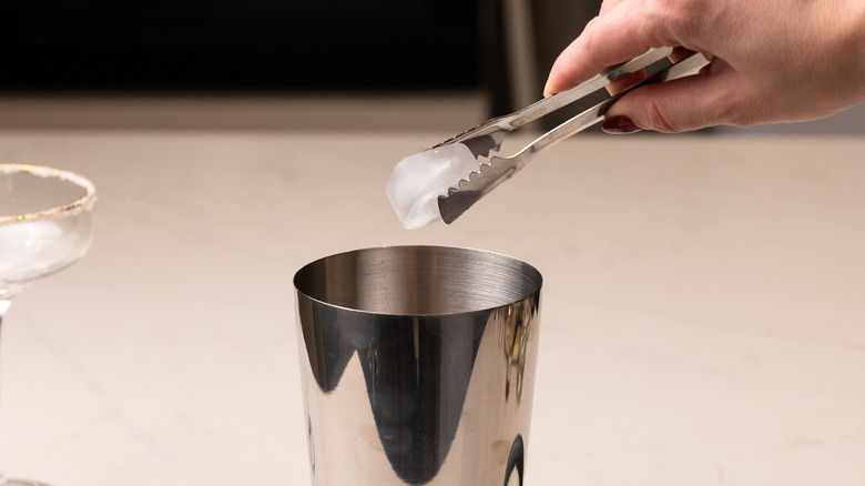 adding ice to cocktail shaker