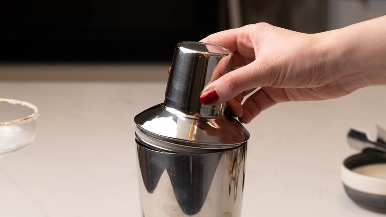 placing lid on cocktail shaker
