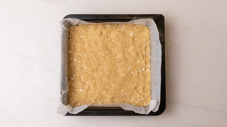 dough pressed into baking pan