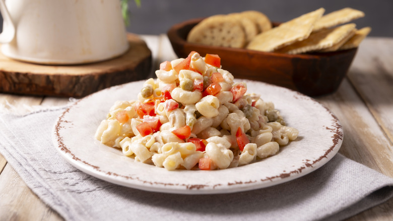 Pasta with red peppers and green peas on a plate