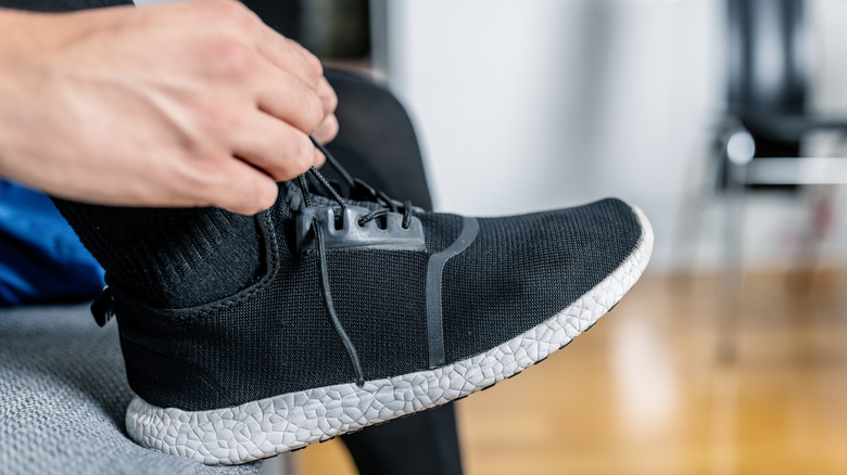 close up of person tying sneakers