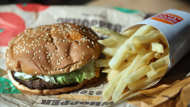 close up of Whopper hamburger with fries