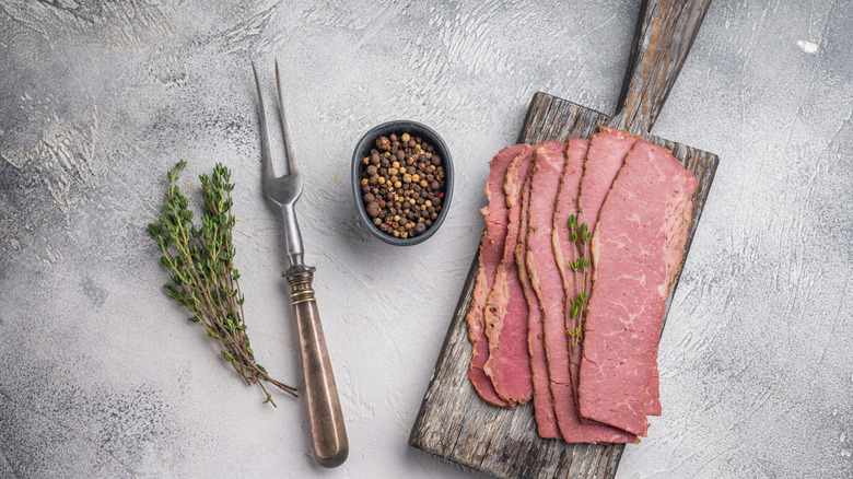 Slices of pastrami on a chopping board