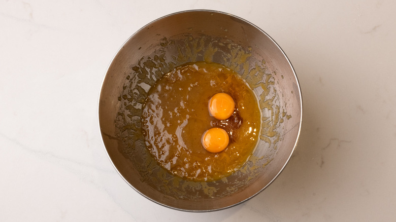 adding eggs to cookie dough