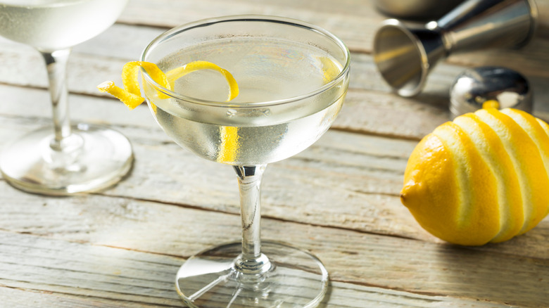 Vesper in coupe with lemon peel on table.