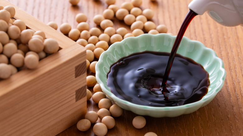 Soy sauce pouring soy beans