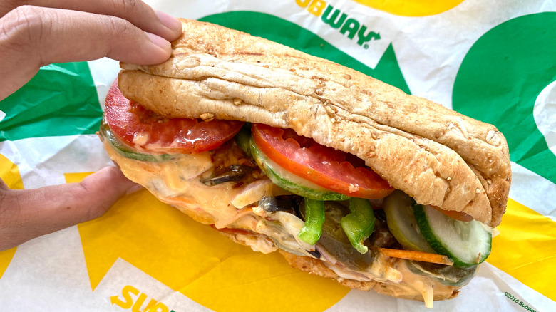 hand grabbing Subway sandwich