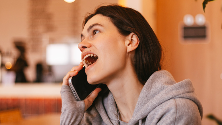 woman talking on smartphone in cafe