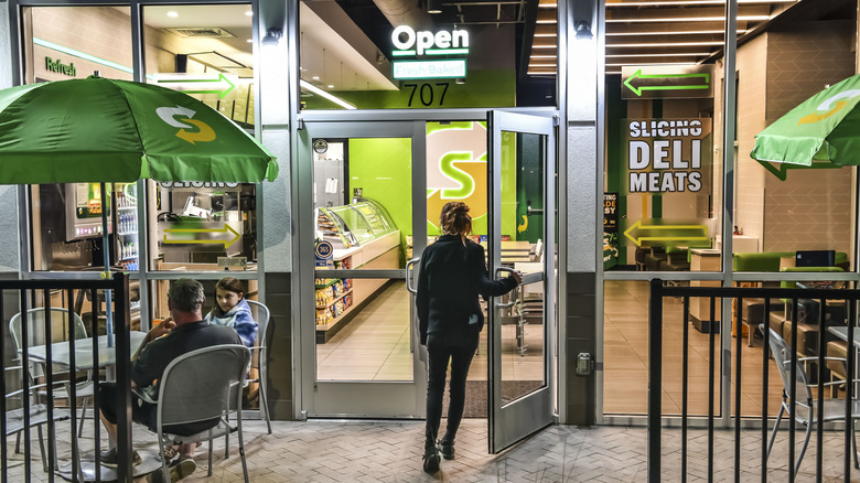 Customer entering subway at night time